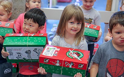 Children holding donation boxes